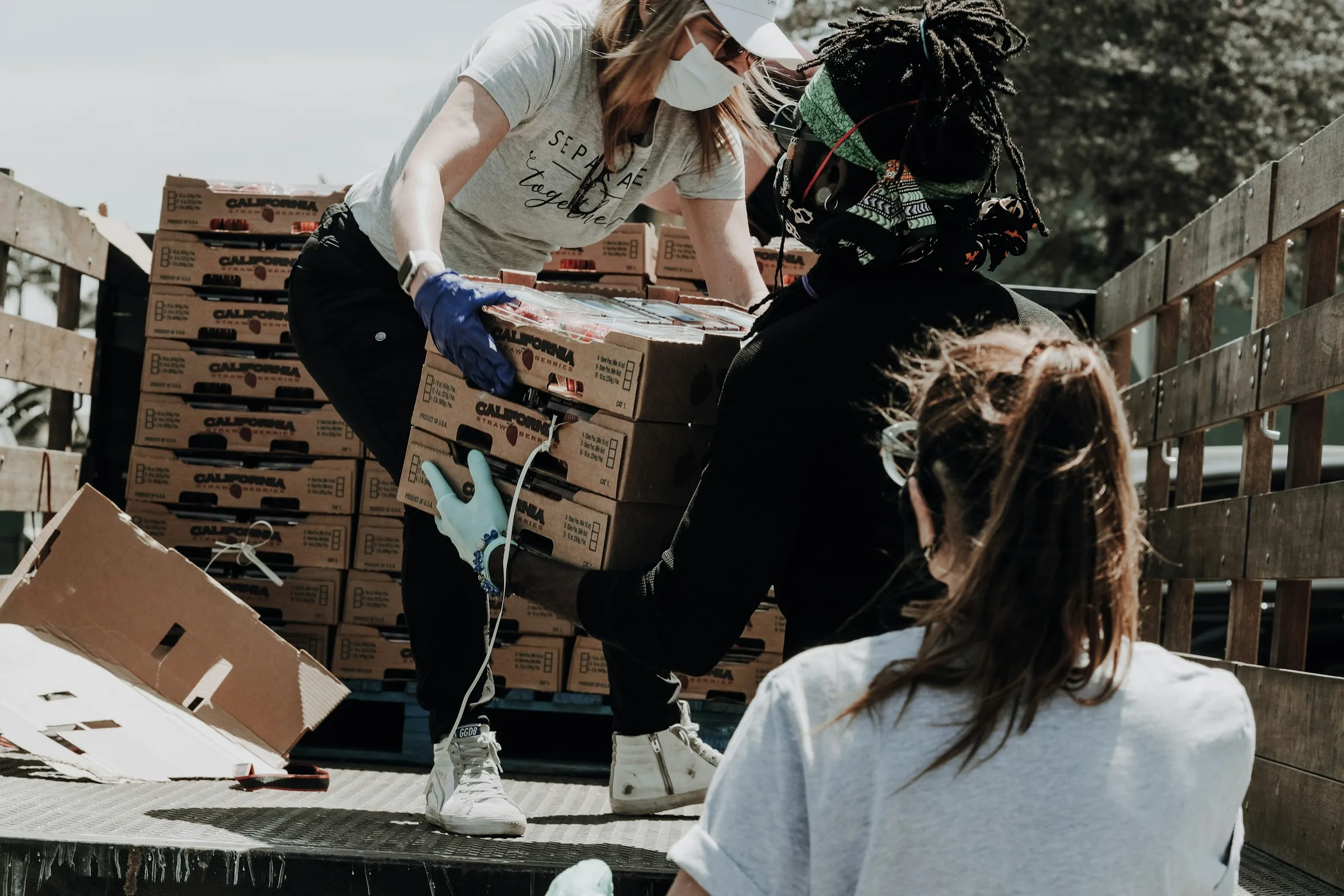 Volunteers handling aid supply boxes